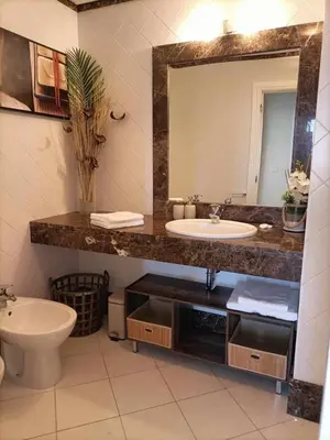 a bathroom with a sink and a toilet and a mirror at GuestReady - Vila Formosa in Funchal