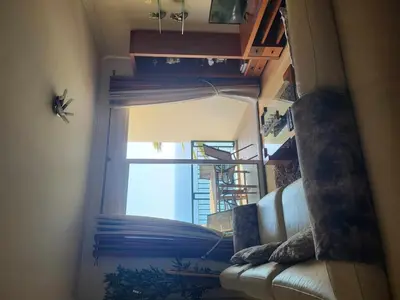 a living room with a couch and a window at GuestReady - Vila Formosa in Funchal