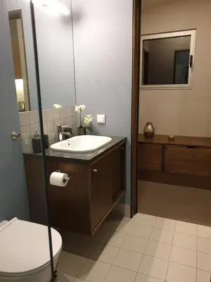 a bathroom with a sink and a toilet and a mirror at Casa Atlantico Dachterrassengeschoss in Ribeira Brava