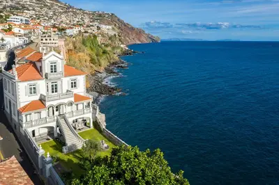 a large white building on the side of the water at Luxury Barreirinha House old town by Holiday Rental Madeira in Funchal