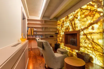 a living room with two chairs and a fireplace at Luxury Barreirinha House old town by Holiday Rental Madeira in Funchal