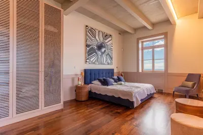 a bedroom with a blue bed and a window at Luxury Barreirinha House old town by Holiday Rental Madeira in Funchal