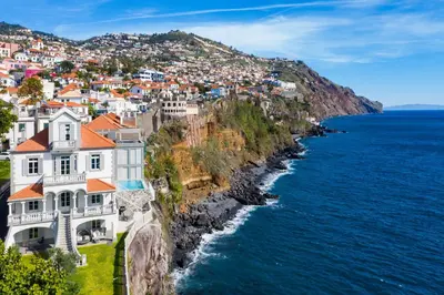 a house on a cliff next to the ocean at Luxury Barreirinha House old town by Holiday Rental Madeira in Funchal