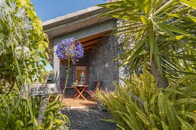 a stone house with a sign in front of it at Quinta Devónia by An Island Apart in Funchal