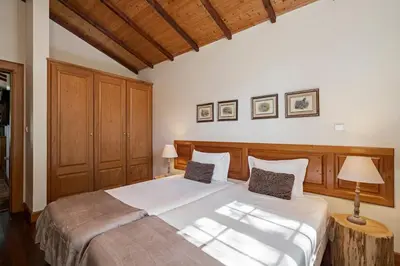 a bedroom with a large white bed with two pillows at Quinta Devónia by An Island Apart in Funchal