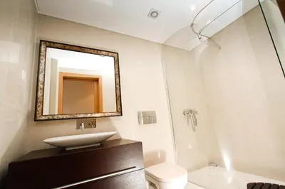a bathroom with a sink and a toilet and a mirror at Madeira Luxury Villas Living Funchal in Funchal