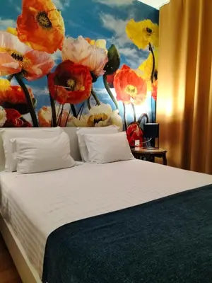 a bedroom with a bed with a painting of flowers at Madeira Luxury Villas Living Funchal in Funchal