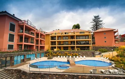 a resort with a swimming pool and some buildings at Madeira Luxury Villas Living Funchal in Funchal