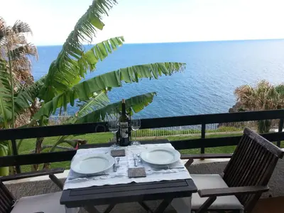 a table with a view of the ocean at Chuva De Prata in Caniço