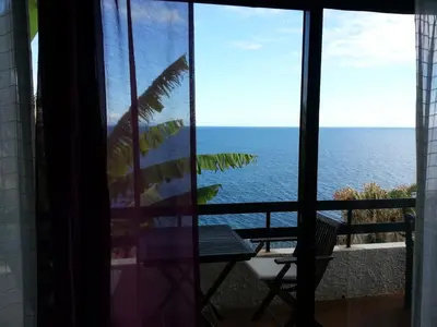 a view of the ocean from a window at Chuva De Prata in Caniço
