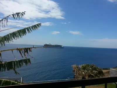 a large container ship in the ocean with at Chuva De Prata in Caniço
