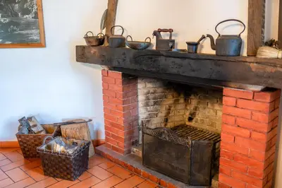 an open door of a pink house with a brick driveway at Casa da Tia Clementina in Santana