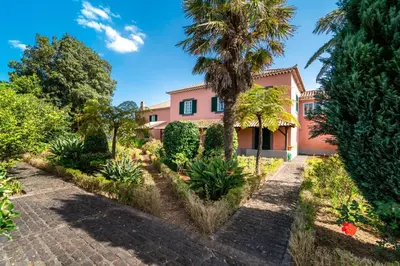 a bedroom with a bed and a large window at Casa da Tia Clementina in Santana