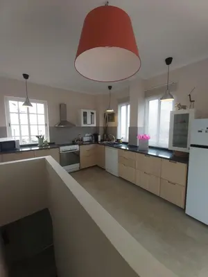 a large kitchen with a white refrigerator and a red light at Banda Do Sol Self Catering Cottages in Estreito da Calheta