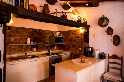 a kitchen with a sink and a stove top oven at Casa da Montanha in Luz