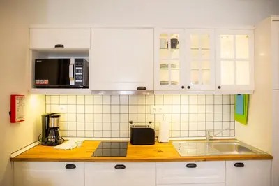 a kitchen with white cabinets and a counter top at Casa da Montanha in Luz