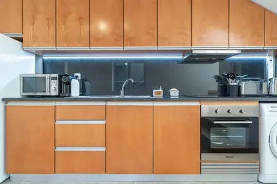 a kitchen with a sink and a microwave at Casa Leonardo in Arco da Calheta