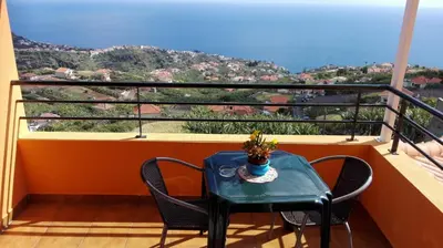 a table and chairs on a balcony with a view at Lindo Apartamento Villa in Ponta do Sol