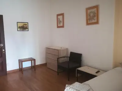 a bedroom with a bed and a chair and a desk at Cc39- Q5 in Funchal
