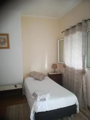 a bedroom with a white bed and a window at Cc39- Q5 in Funchal