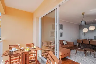 a living room with a table and a couch at Reis Magos III by An Island Apart in Caniço