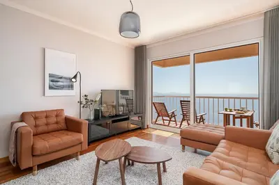 a living room with a couch and a table at Reis Magos III by An Island Apart in Caniço