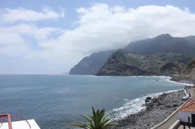 a view of the ocean and a mountain at Hotel Vila Bela in Porto da Cruz
