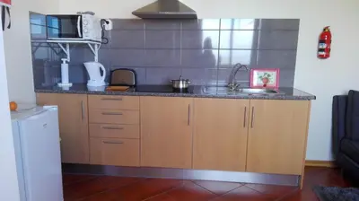a kitchen with a sink and a counter top at Appartamento Villa in Ponta do Sol