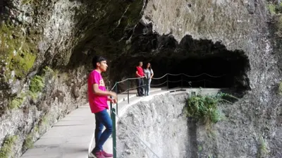 a man standing in front of a cave at Appartamento Villa in Ponta do Sol