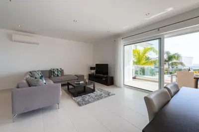 a living room with a couch and a tv at Porto de Mós 85 by Destination Algarve in Lagos