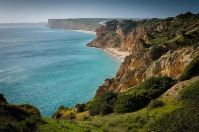 a view of the ocean from a cliff at Porto de Mós 85 by Destination Algarve in Lagos