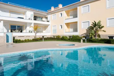 an image of a swimming pool in front of a building at Porto de Mós 85 by Destination Algarve in Lagos