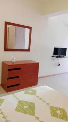 a bedroom with a dresser and a mirror on the wall at Apartamento Villa in Ponta do Sol