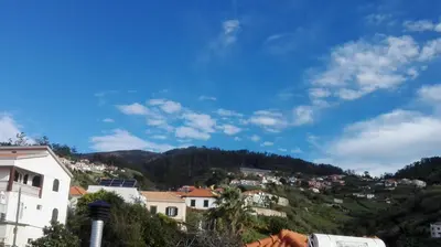 a view of a town on a hill at Apartamento Villa in Ponta do Sol