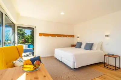 a bedroom with a bed and a table with a bowl of fruit at Casa da Cal - by Casas na Ilha in Câmara de Lobos