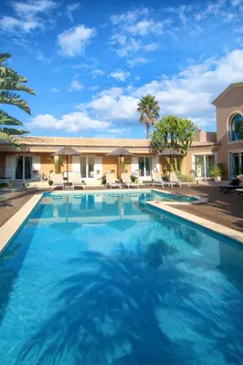 a swimming pool in front of a house at Casa Canavial in Luz