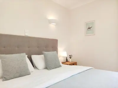 a bedroom with a bed with white sheets and pillows at Casa Canavial in Luz