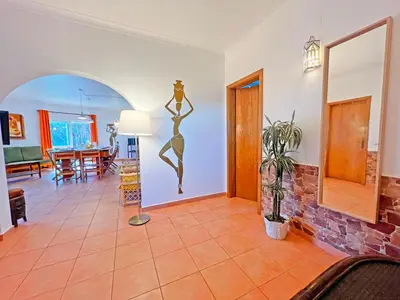 a living room with a mirror and a table at Private Villa Rego with Oceanview and Pool in Luz