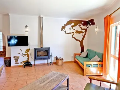 a living room with a tree mural on the wall at Private Villa Rego with Oceanview and Pool in Luz