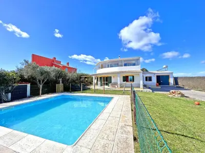 a villa with a swimming pool in front of a house at Private Villa Rego with Oceanview and Pool in Luz