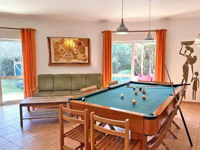 a living room with a pool table and a couch at Private Villa Rego with Oceanview and Pool in Luz