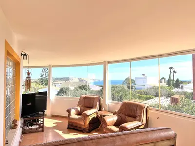 a living room with two chairs and a large window at Private Villa Rego with Oceanview and Pool in Luz