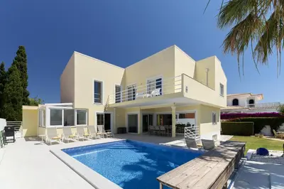 a villa with a swimming pool and a house at Porto de Mos 95 by Destination Algarve in Lagos