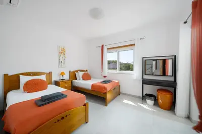 a kitchen and dining room with a white table and chairs at Porto de Mos 95 by Destination Algarve in Lagos