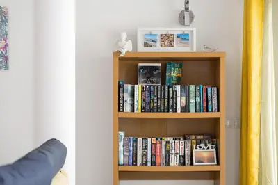 a book shelf filled with books in a room at Porto de Mos 95 by Destination Algarve in Lagos