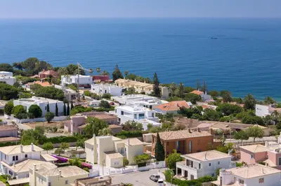 a white bedroom with a bed and a balcony at Porto de Mos 95 by Destination Algarve in Lagos