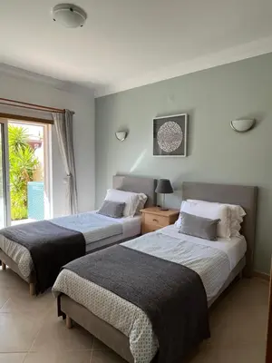 two beds in a room with a window at Luxury apartment with free use of pool, gym and spa in Lagos