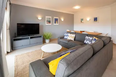 a living room with a couch and a tv at Luxury apartment with free use of pool, gym and spa in Lagos