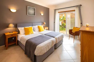 a bedroom with a large bed with yellow pillows at Luxury apartment with free use of pool, gym and spa in Lagos