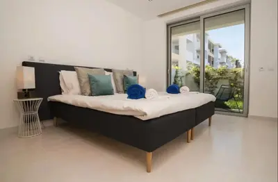 a large bed in a room with a large window at ZENTUNI Ocean front in Lagos